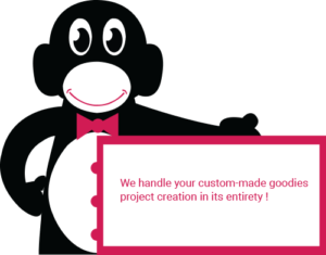 Nigule holding a sign where it is written "We handle your custom made goodies project creation in its entierety"